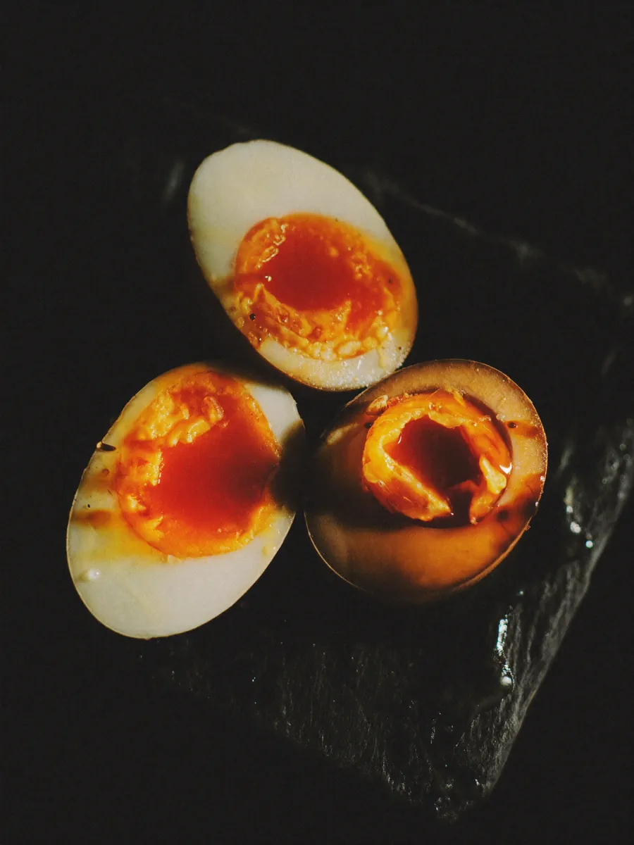 Macro shot of halved marinated soft-boiled eggs